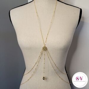 Gold body jewelry with evil eye decor